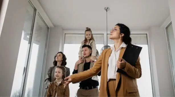 Real estate agent showing family new home