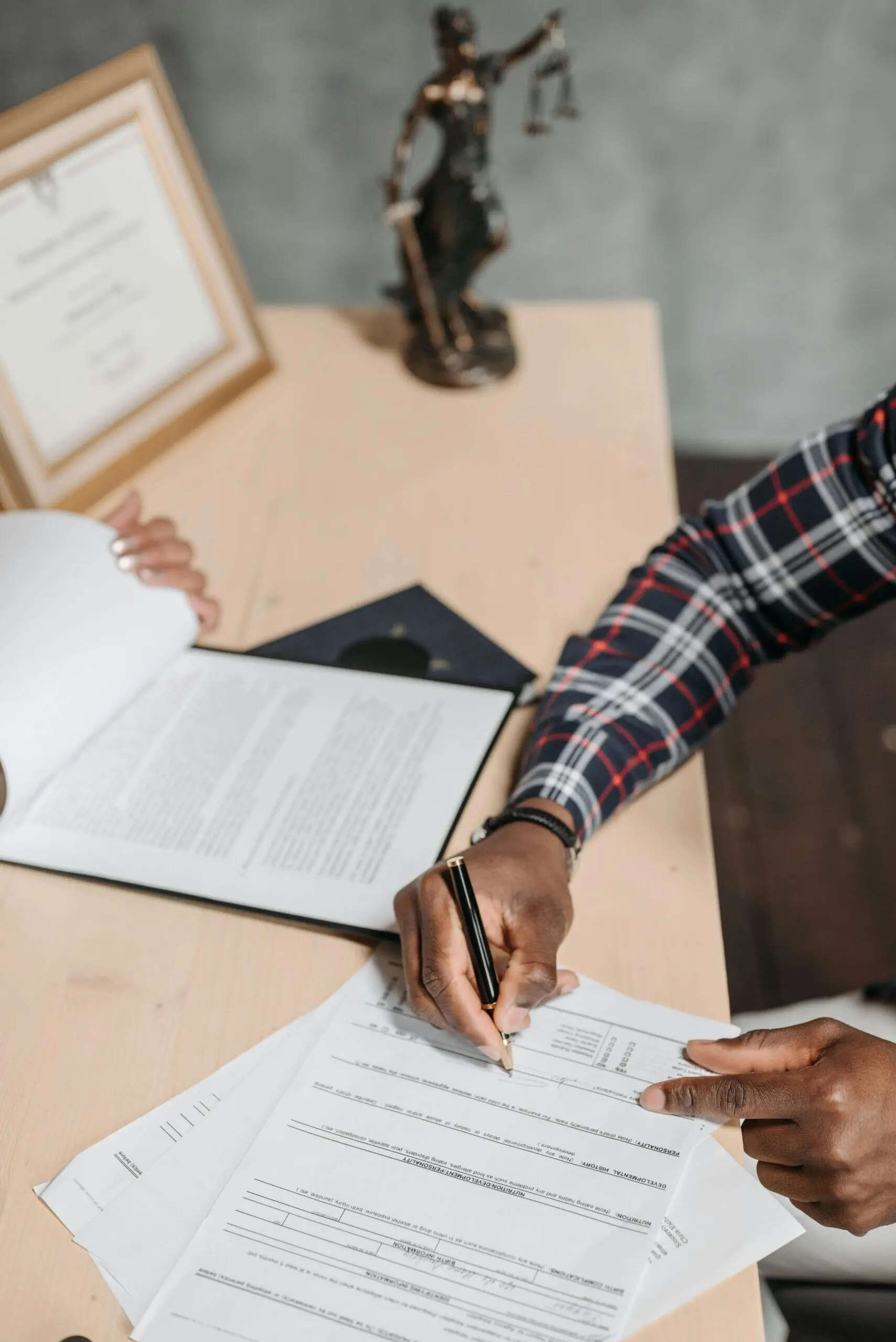 Lawyer reviewing legal documents, pen in hand. Australian AML compliance.